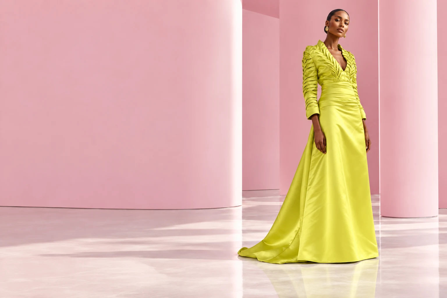 ALOSH chartreuse satin gown with hand-smocked detailing and a sweeping train in a pink studio